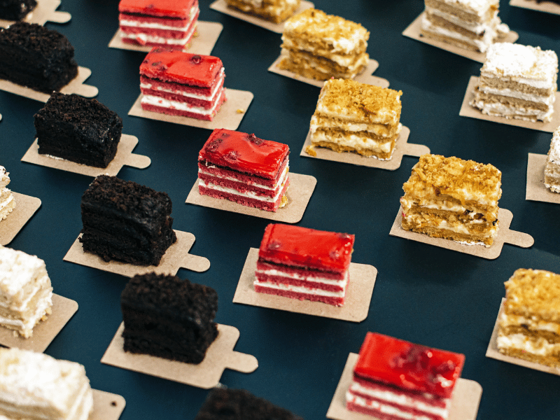 Assortment of different types of cake on a table.