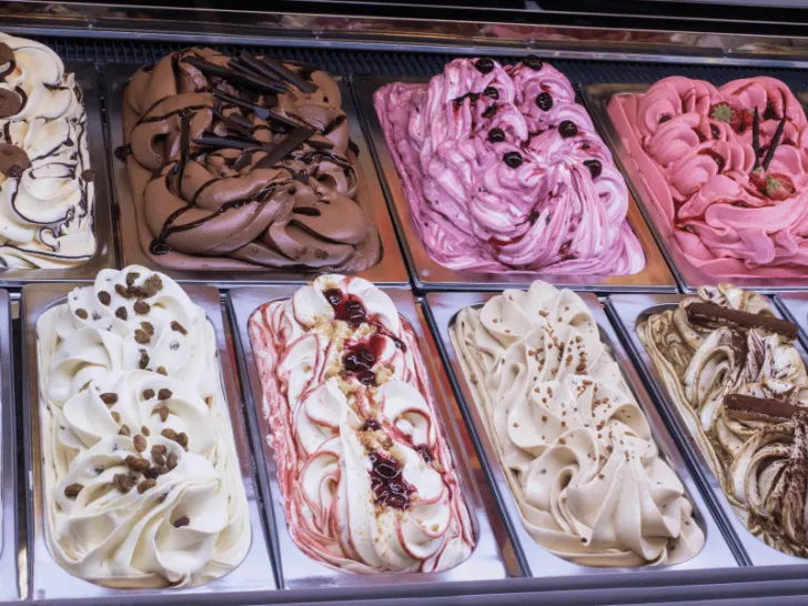 A display of various ice cream flavors in a case.