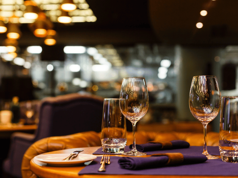 A place setting with wine glasses and a napkin in a favorite restaurant.