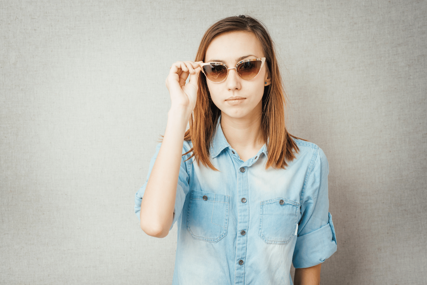 Description: A young woman wearing sunglasses and a denim shirt shares tips on how to become a brand ambassador.